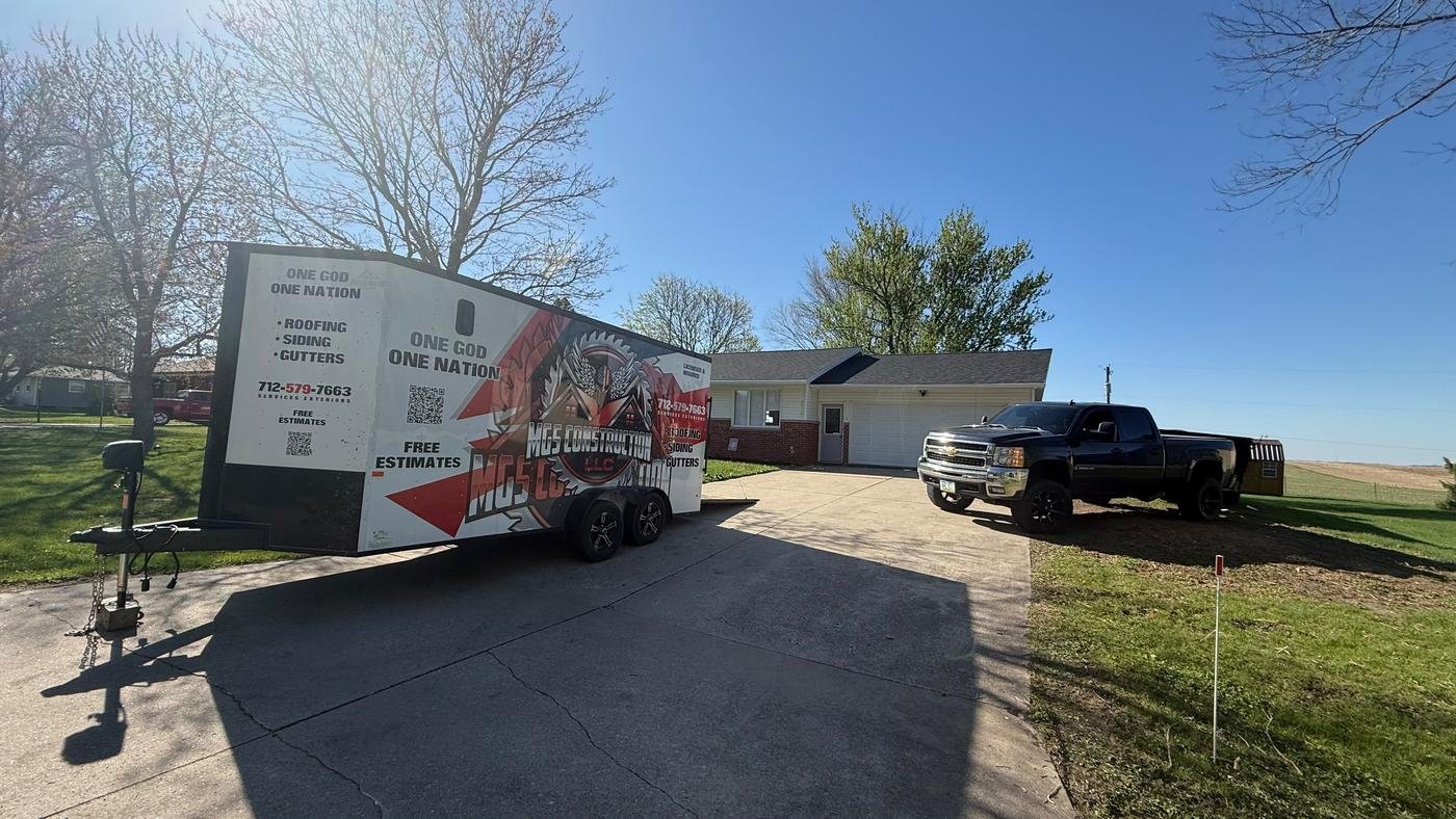 MGS Construction branded trailer and truck at a job site