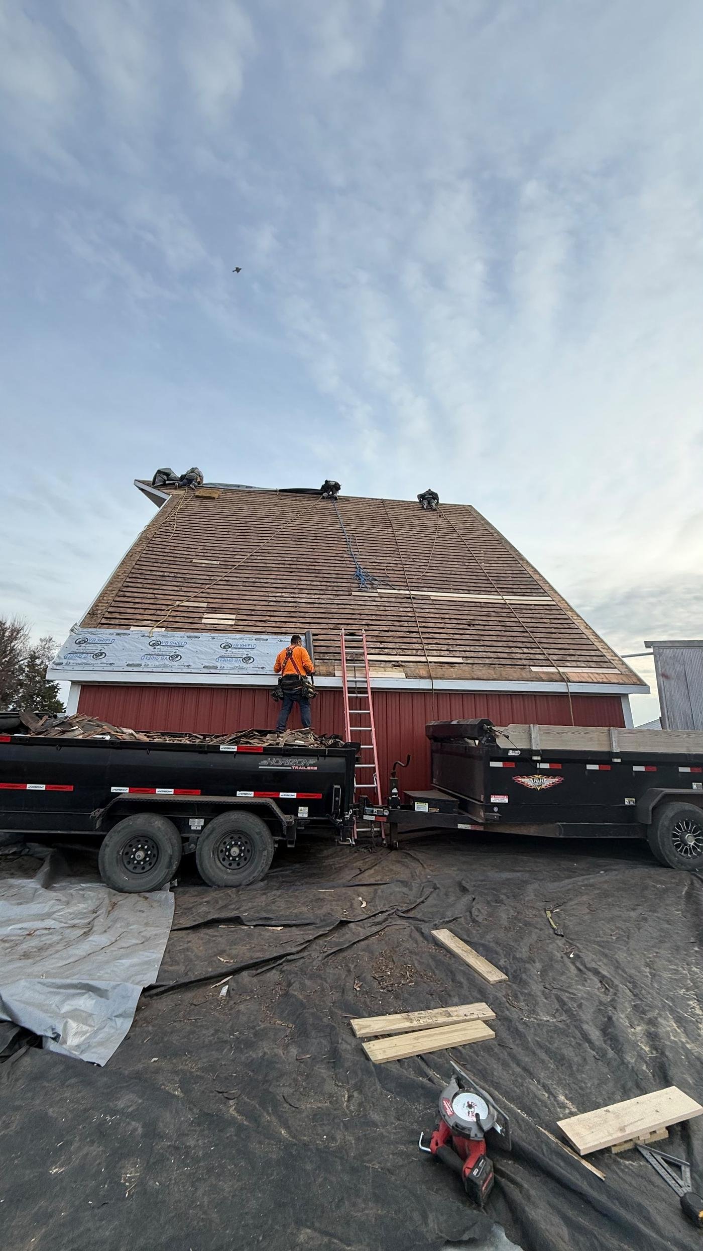 MGS Construction crew re-roofing a barn