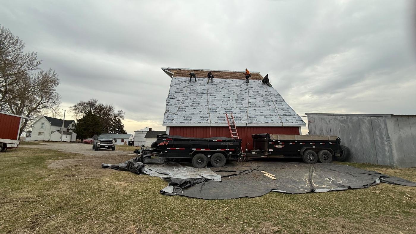 MGS Construction crew working on a barn roof